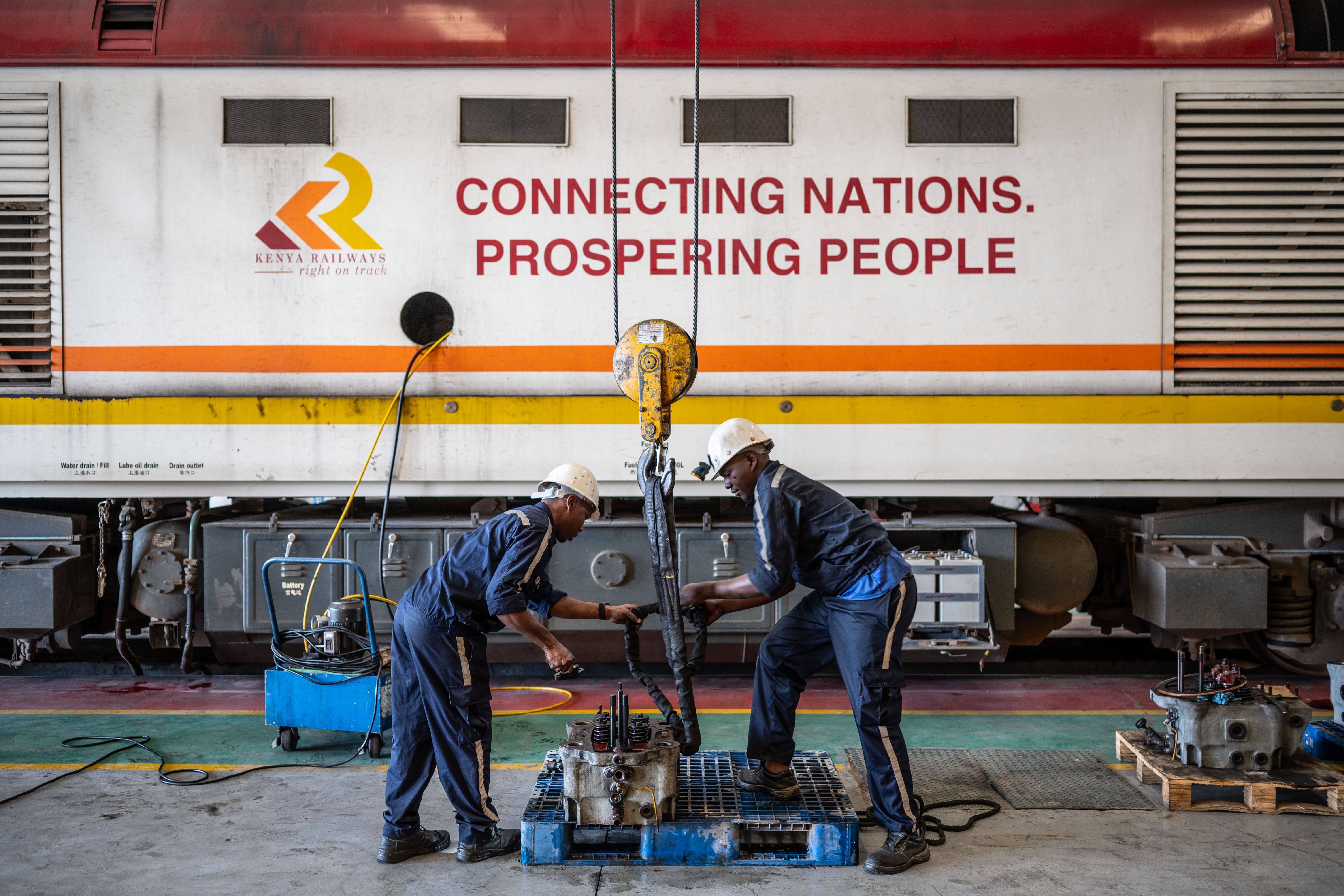 Maintenance workers check locomotive parts in the repair workshop of the Mombasa-Nairobi Railway in Nairobi, Kenya.