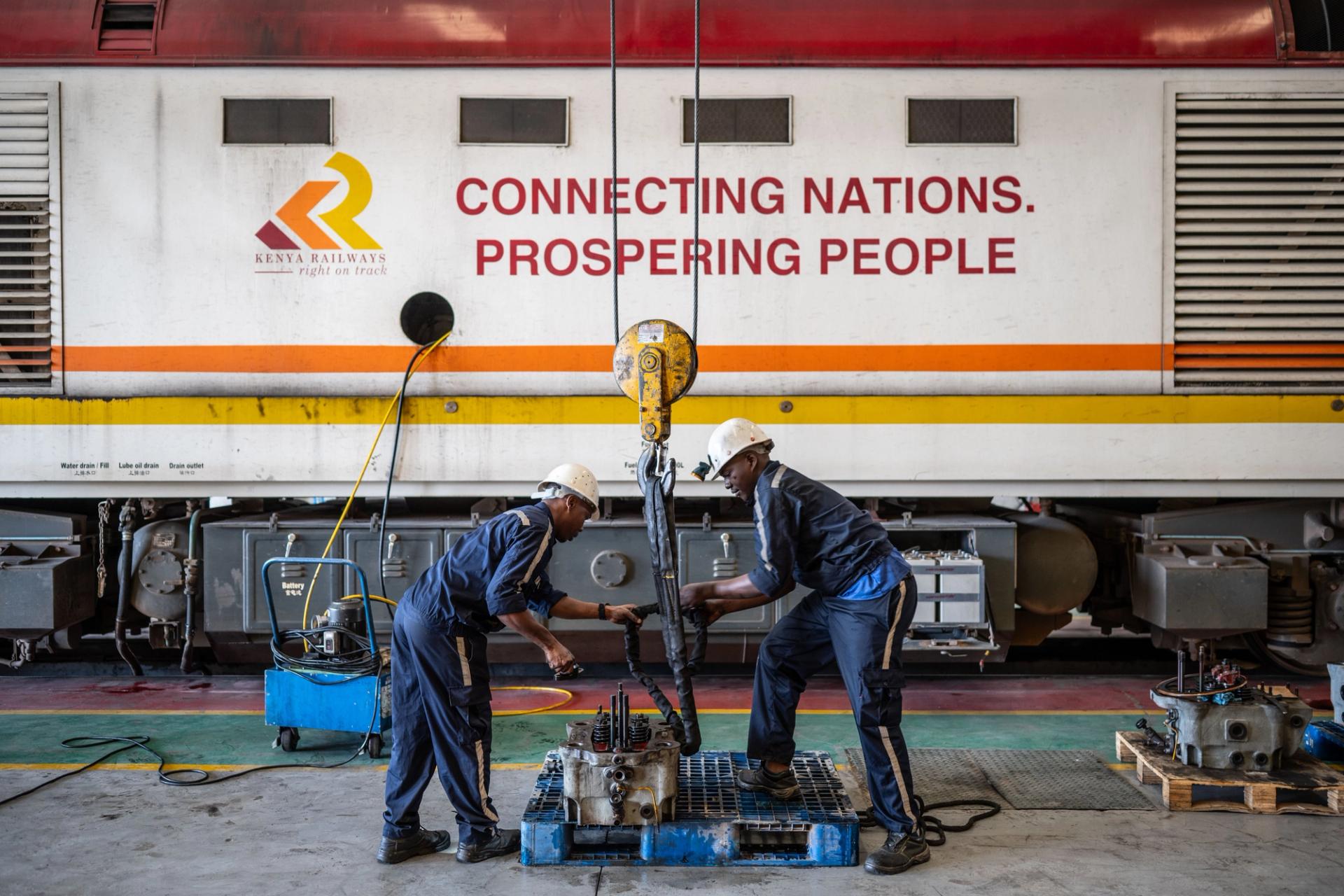 Maintenance workers check locomotive parts in the repair workshop of the Mombasa-Nairobi Railway in Nairobi, Kenya.