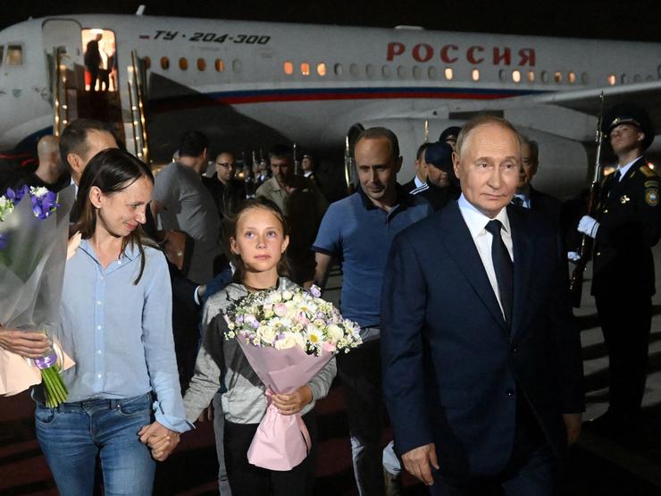 Russian President Vladimir Putin welcomes Russian nationals, including Artyom Dultsev, Anna Dultseva and their children, following a prisoner exchange between Russia with Western countries on Aug. 1, 2024.
