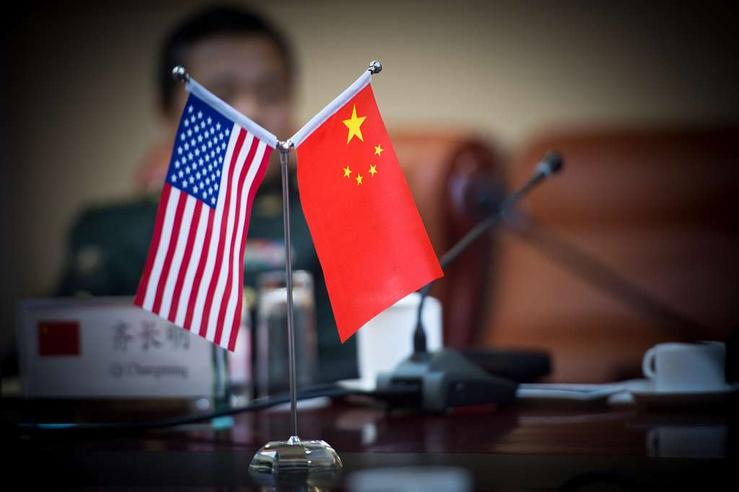 An American flag next to a Chinese flag