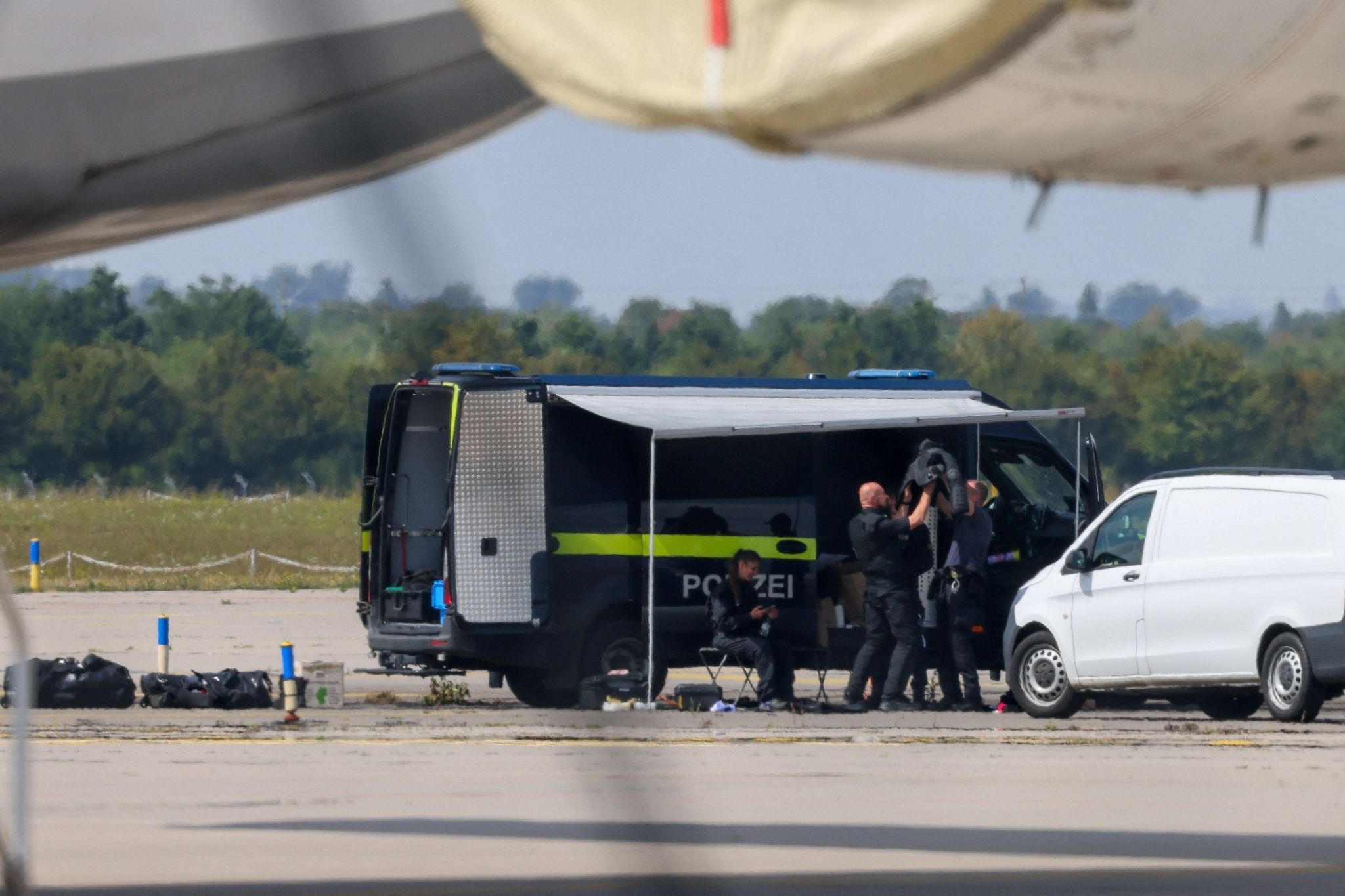Police officers work in the vicinity of an Antonov cargo plane, near which a drone was found, at Leipzig/Halle Airport in Schkeuditz, Germany.