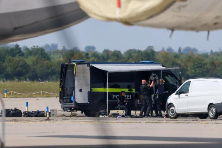 Police officers work in the vicinity of an Antonov cargo plane, near which a drone was found, at Leipzig/Halle Airport in Schkeuditz, Germany.