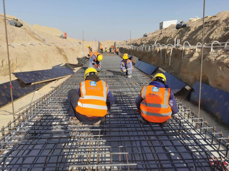 Staff members work at the construction site of South Sabah Al-Ahmad New City project, fulfilled by the China State Construction Engineering Corporation CSCEC, in Ahmadi Governorate, Kuwait