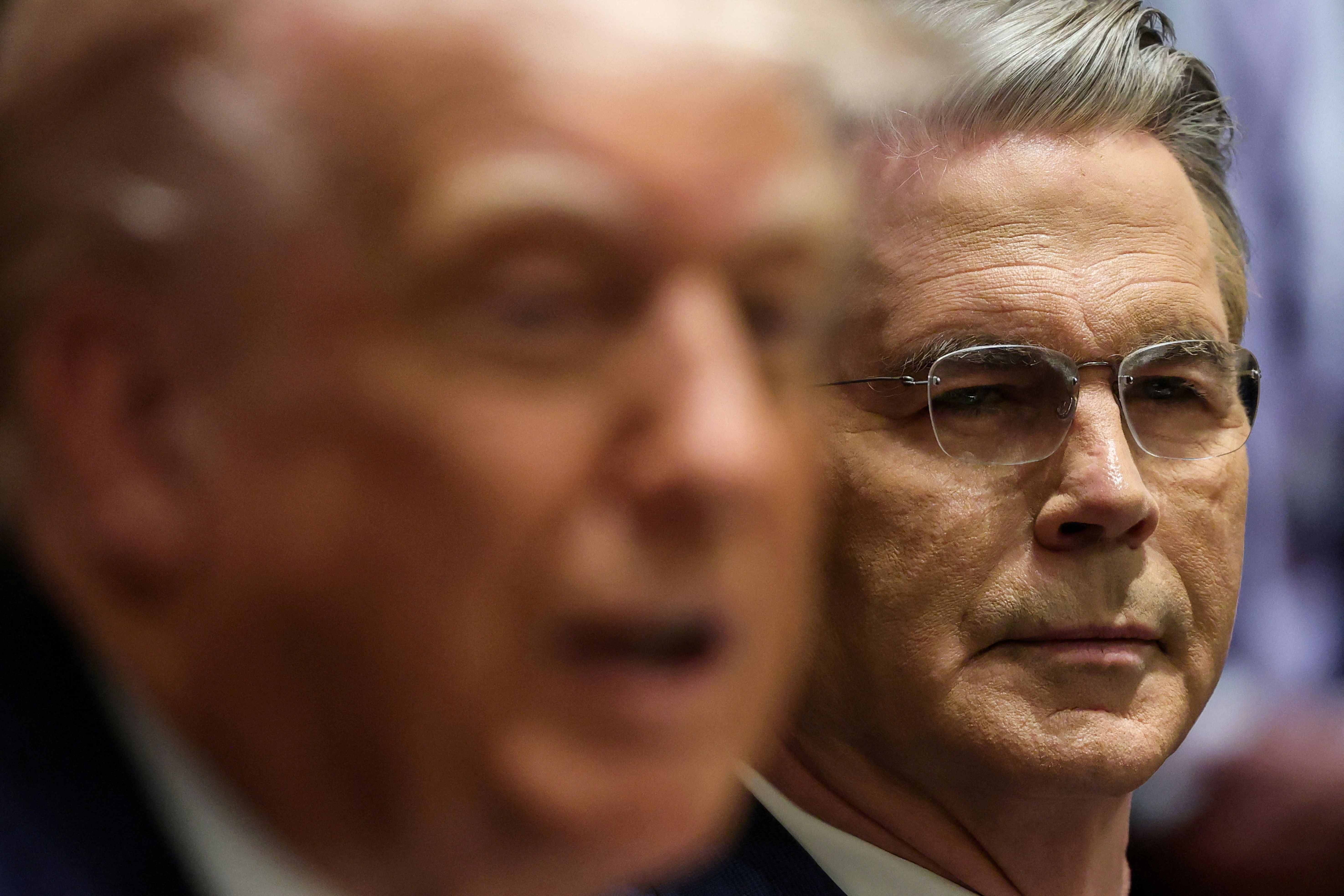 US Secretary of the Treasury Scott Bessent looks on, near US President Donald Trump.