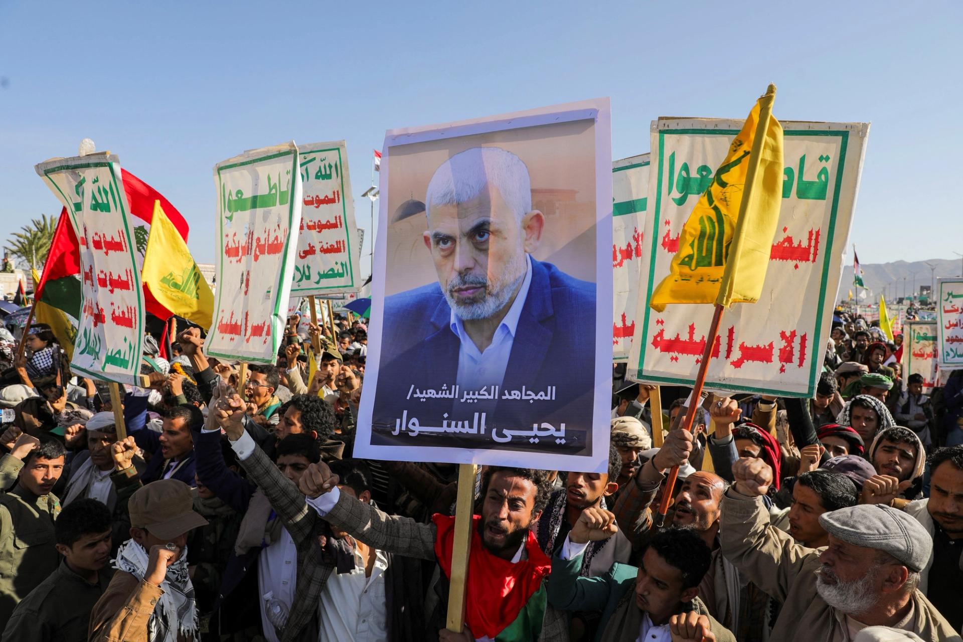 A person holds a sign showing the late Hamas leader Yahya Sinwar as protesters, mainly Houthi supporters, rally to show support to Lebanon’s Hezbollah and Palestinians in the Gaza Strip.