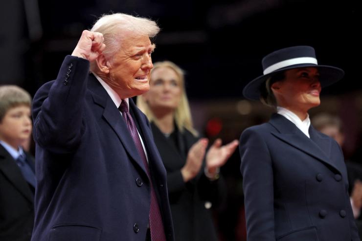 Donald Trump gestures beside first lady Melania Trump during the inaugural parade inside Capital One Arena on the inauguration day of his second presidential term