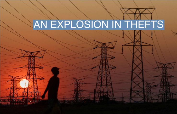 A local walks past electricity pylons during frequent power outages from South African utility Eskom, caused by its aging coal-fired plants, in Orlando, Soweto, South Africa, September 28, 2022.