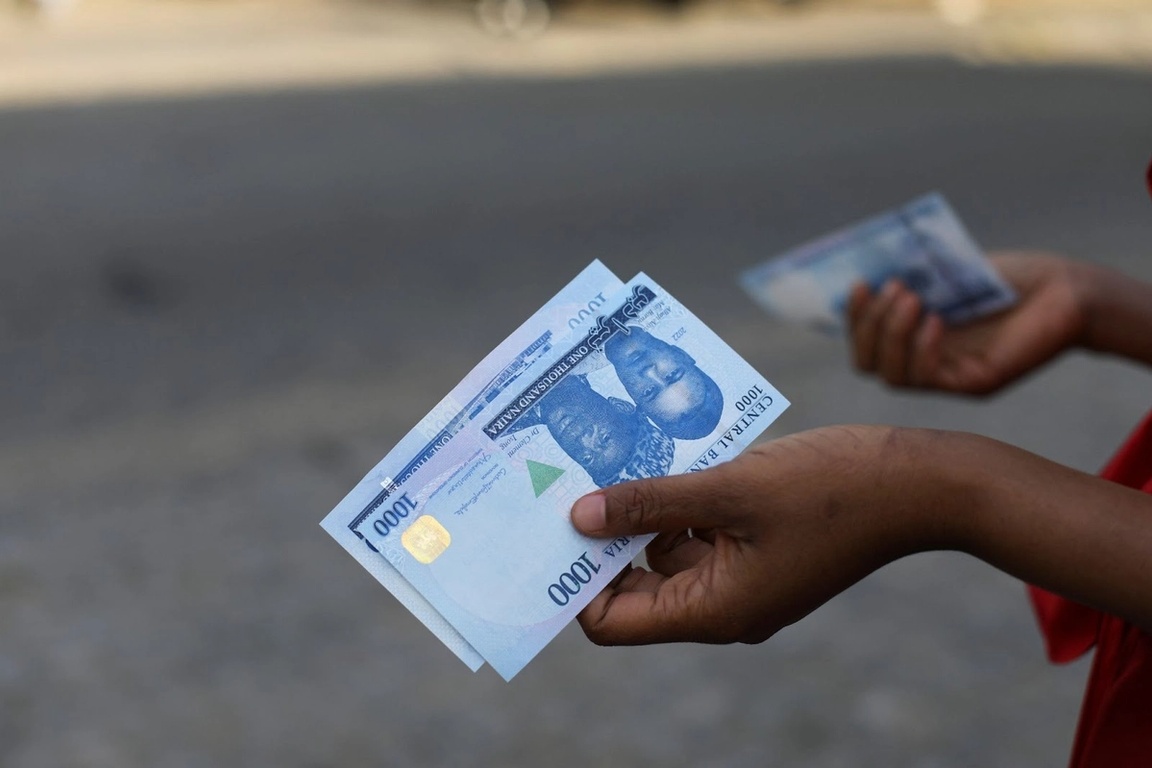 A person holds a new 1000 Naira note in Nigeria on Dec. 15, 2022.