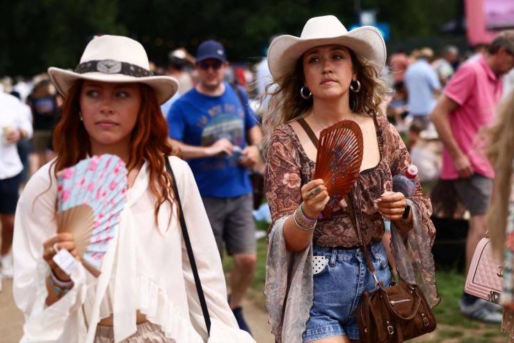 Concert attendees in the UK using fans. Jack Taylor/Reuters