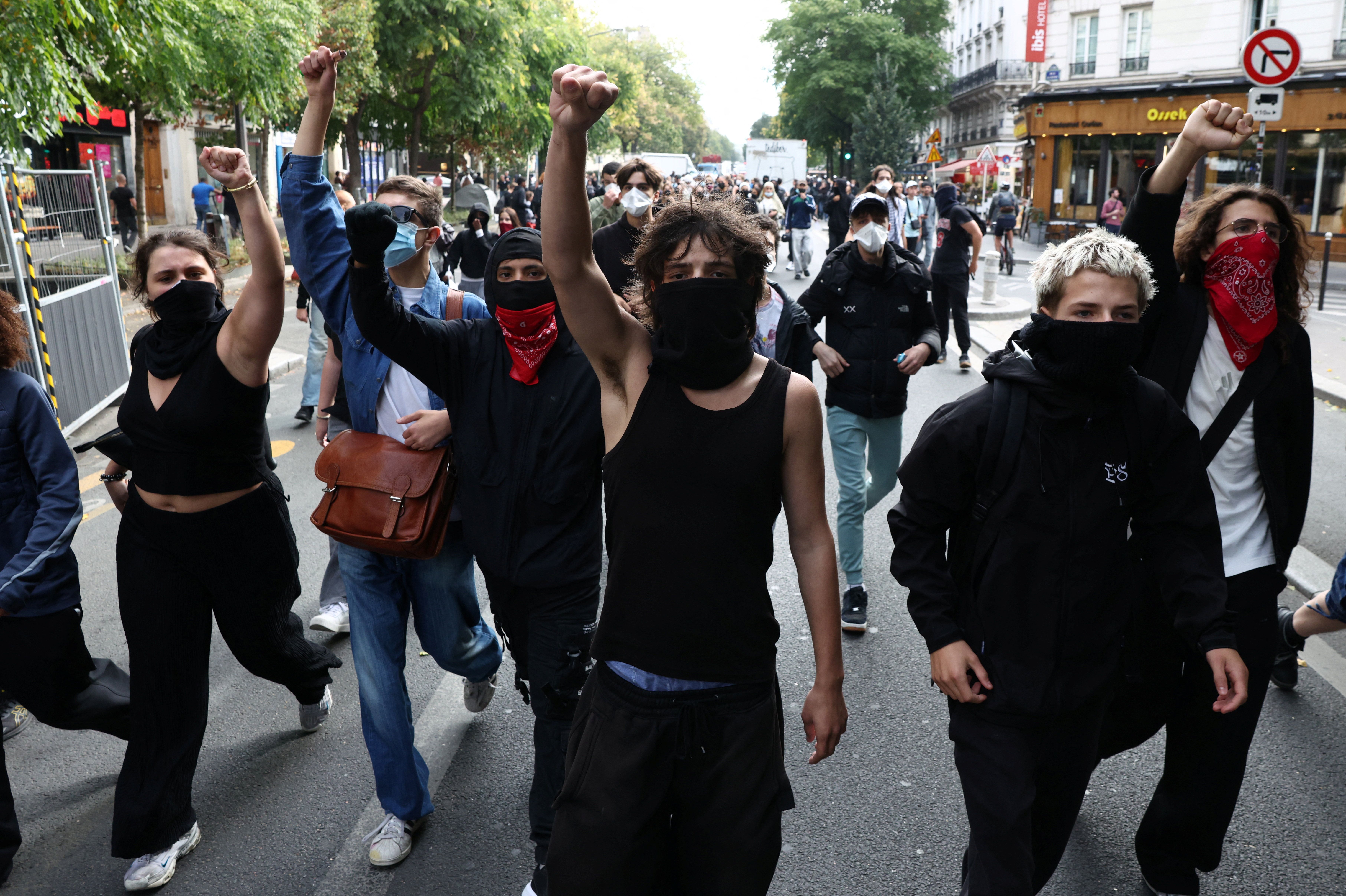 Masked protesters march on the day of a demonstration by high school and university students in Paris which students blame on years of underinvestment, France, Oct. 6, 2026.