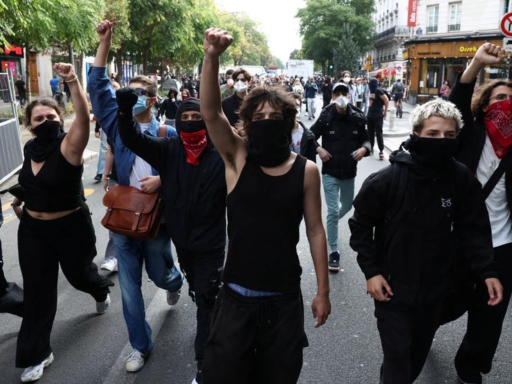 Masked protesters march on the day of a demonstration by high school and university students in Paris which students blame on years of underinvestment, France, Oct. 6, 2026.