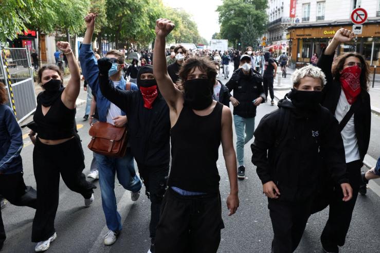 Masked protesters march on the day of a demonstration by high school and university students in Paris which students blame on years of underinvestment, France, Oct. 6, 2026.