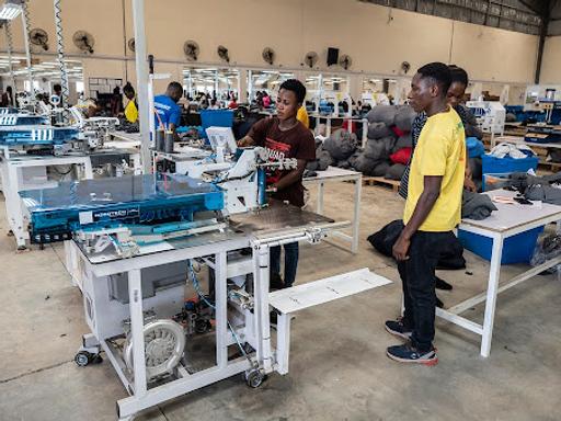 Workers in Ghana sew fabric at a DTRT apparel factory.