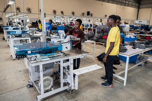 Workers in Ghana sew fabric at a DTRT apparel factory.