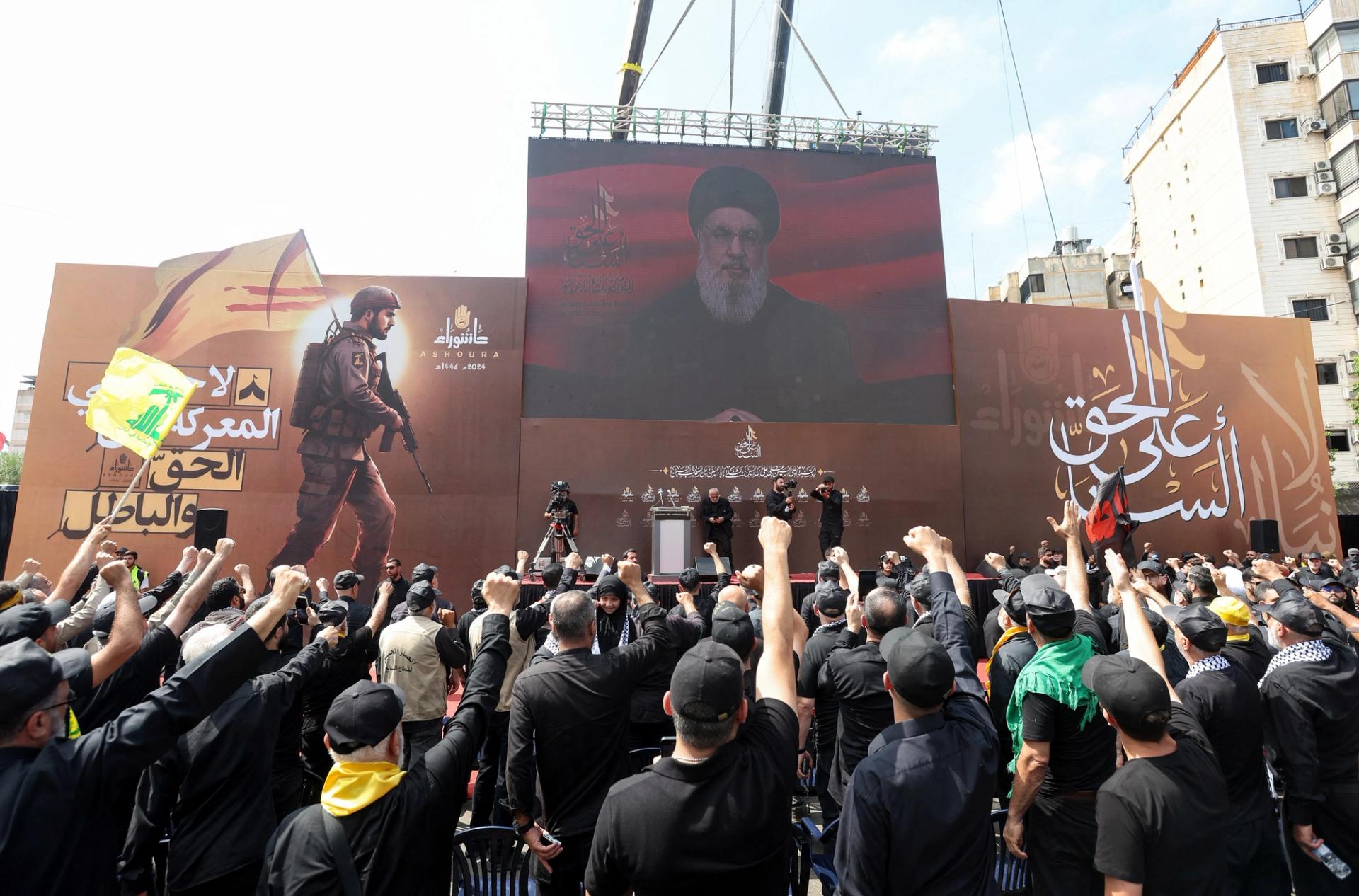 Lebanon's Hezbollah leader Sayyed Hassan Nasrallah appears on a screen as he addresses his supporters during a religious procession to mark Ashura in Beirut's southern suburbs