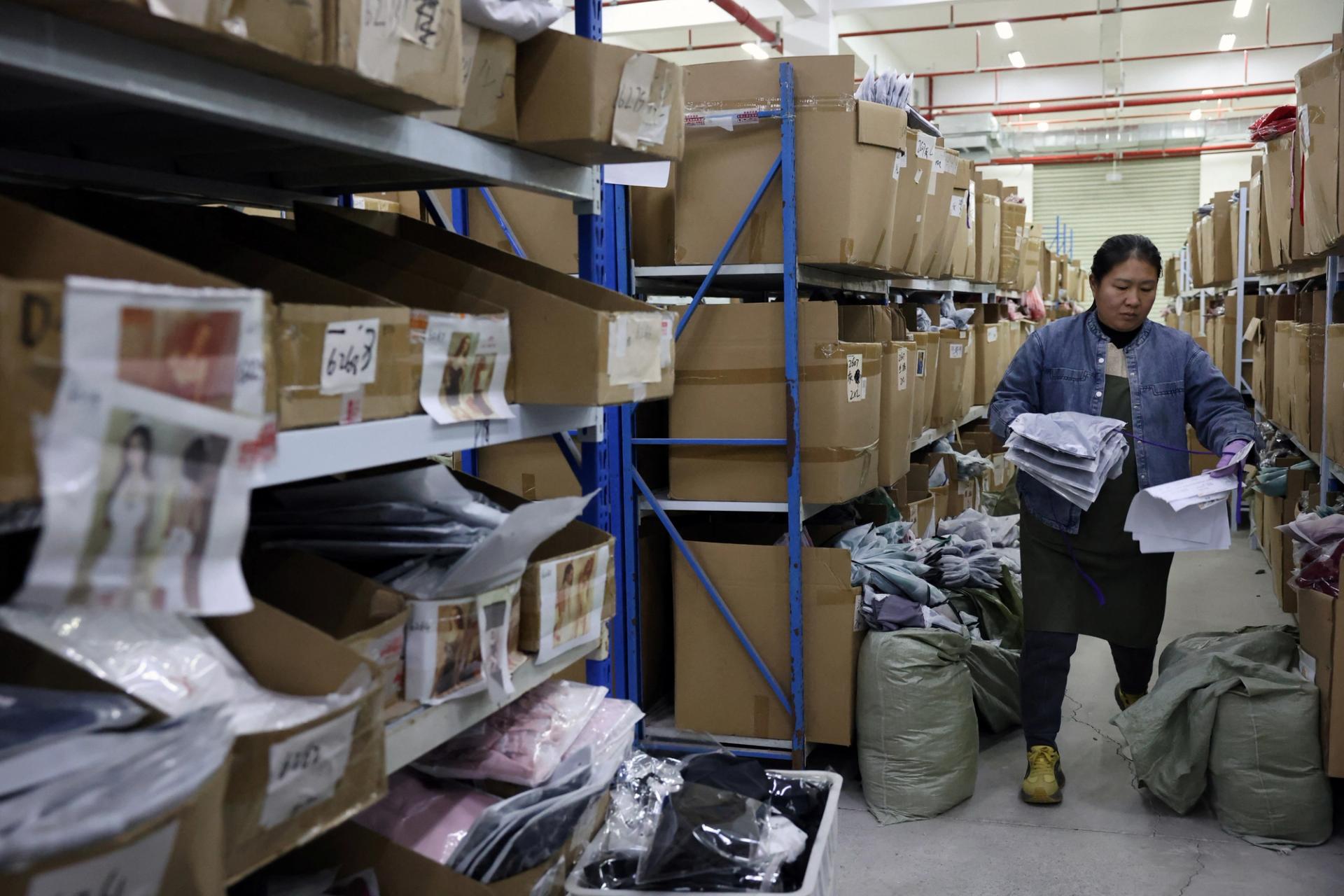 An employee picks up lingerie products at the warehouse of the Midnight Charm Garment lingerie factory in Jiangsu province, China.