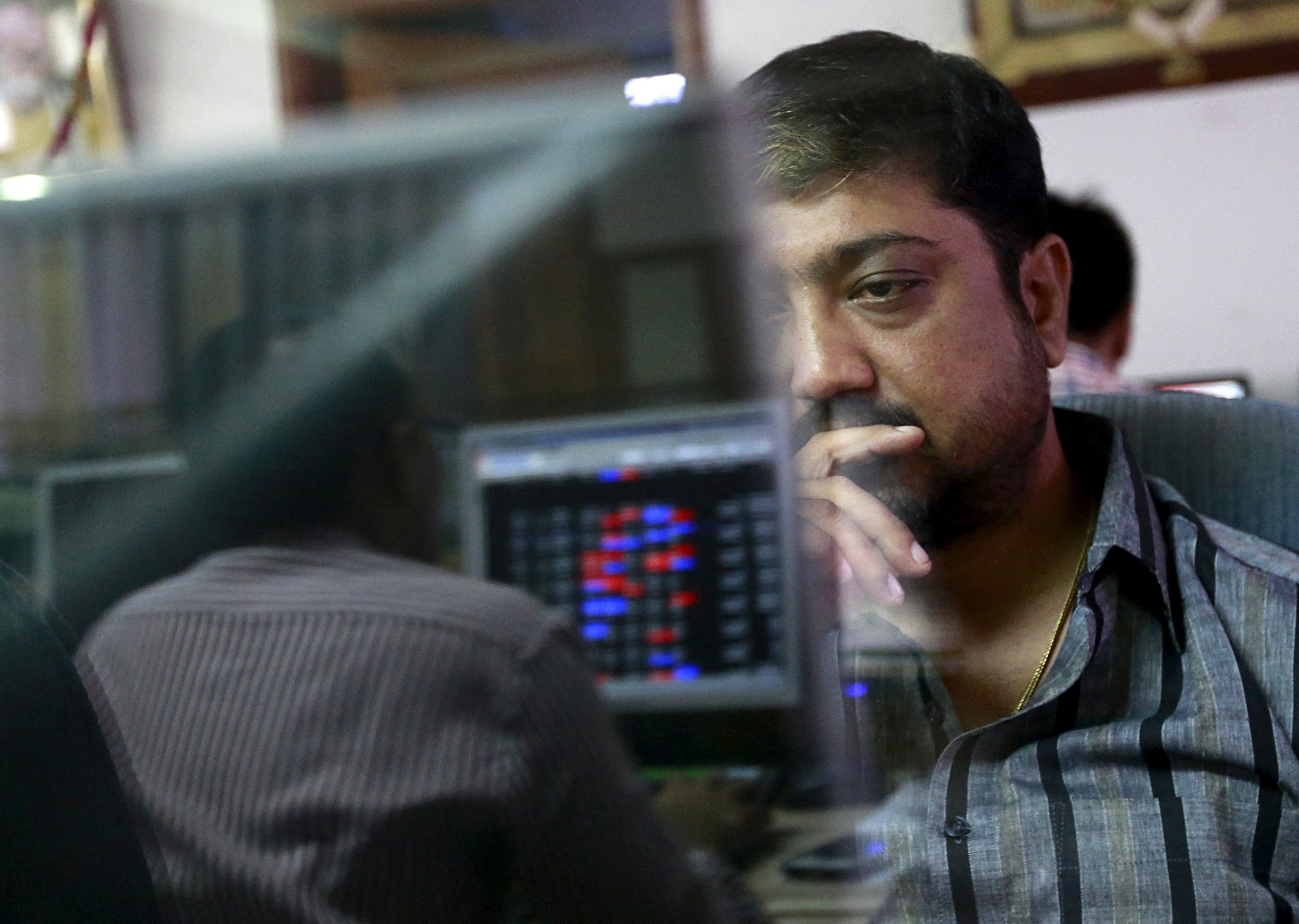 A broker at a stock brokerage firm in Mumbai, India.
