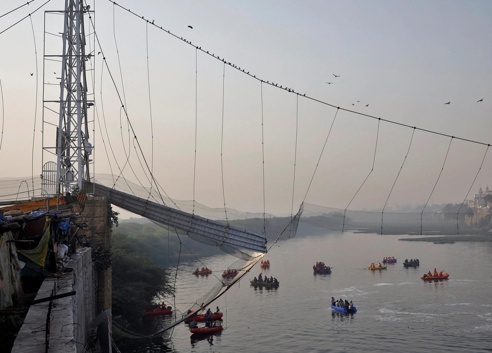 Rescuers search for survivors after a suspension bridge collapsed in Morbi town in the western state of Gujarat, India, October 31, 2022.