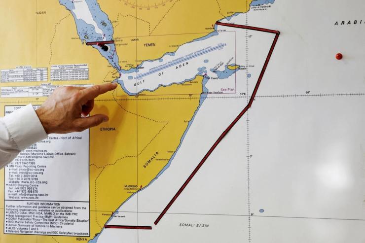 Head of Sea Guardian John Pavlopoulos points at the Gulf of Aden on a map.
