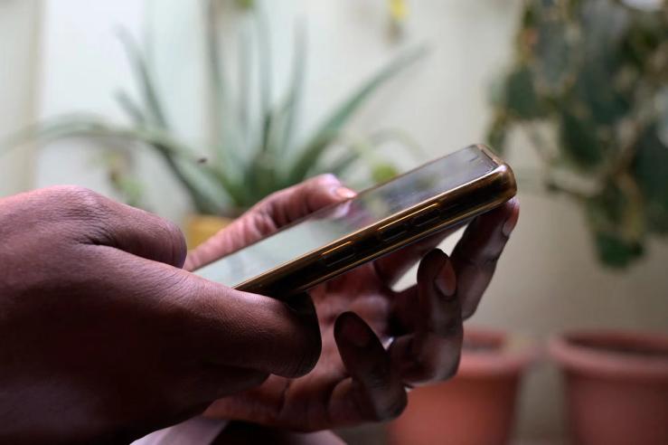 A person holds a mobile phone in Dakar.