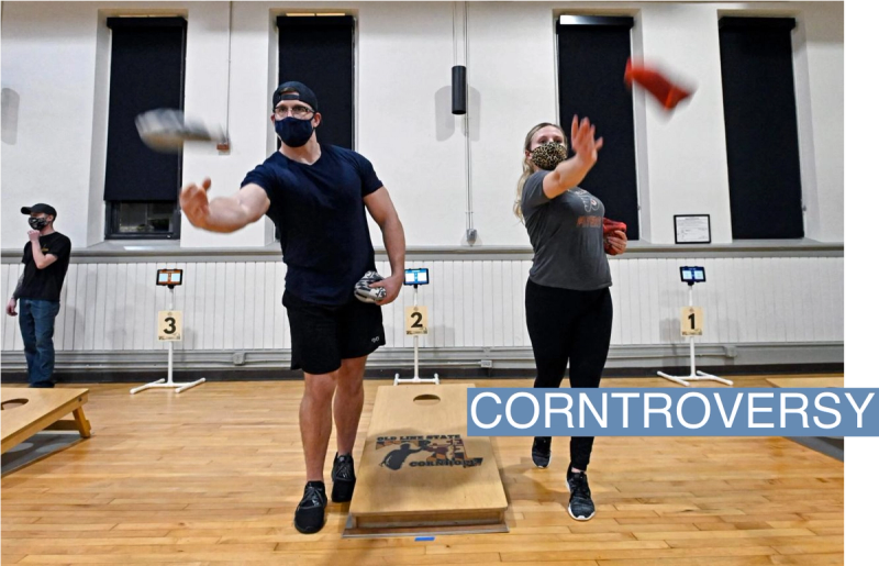 A couple warms up before playing in a cornhole tournament in 2021.