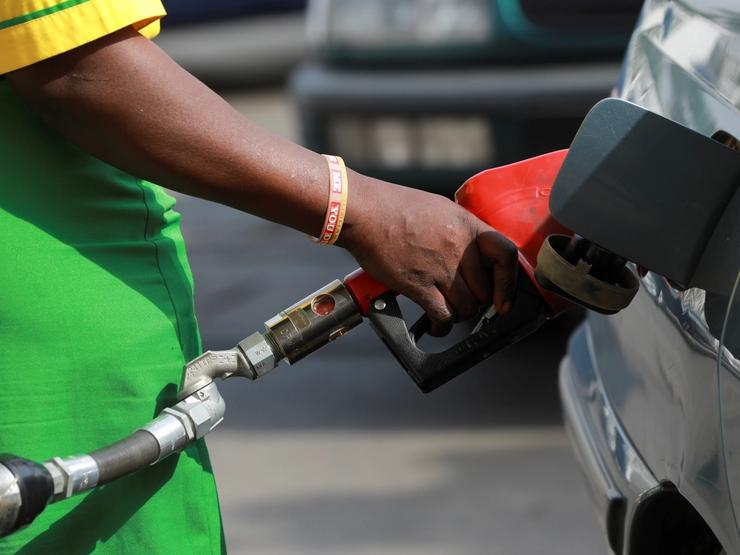 A gas station attendant pumps fuel into a customer’s car at the NNPC Mega petrol station in Abuja, Nigeria March 19, 2020
