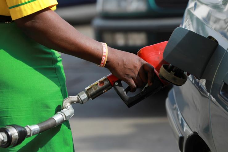 A gas station attendant pumps fuel into a customer’s car at the NNPC Mega petrol station in Abuja, Nigeria March 19, 2020