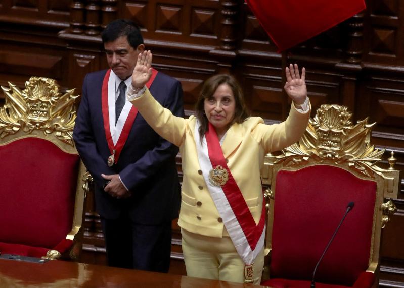 Peru’s interim President Dina Boluarte, who was called on by Congress to take the office after the legislature approved the removal of President Pedro Castillo in an impeachment trial, waves after being sworn-in, in Lima, Peru December 7, 2022.