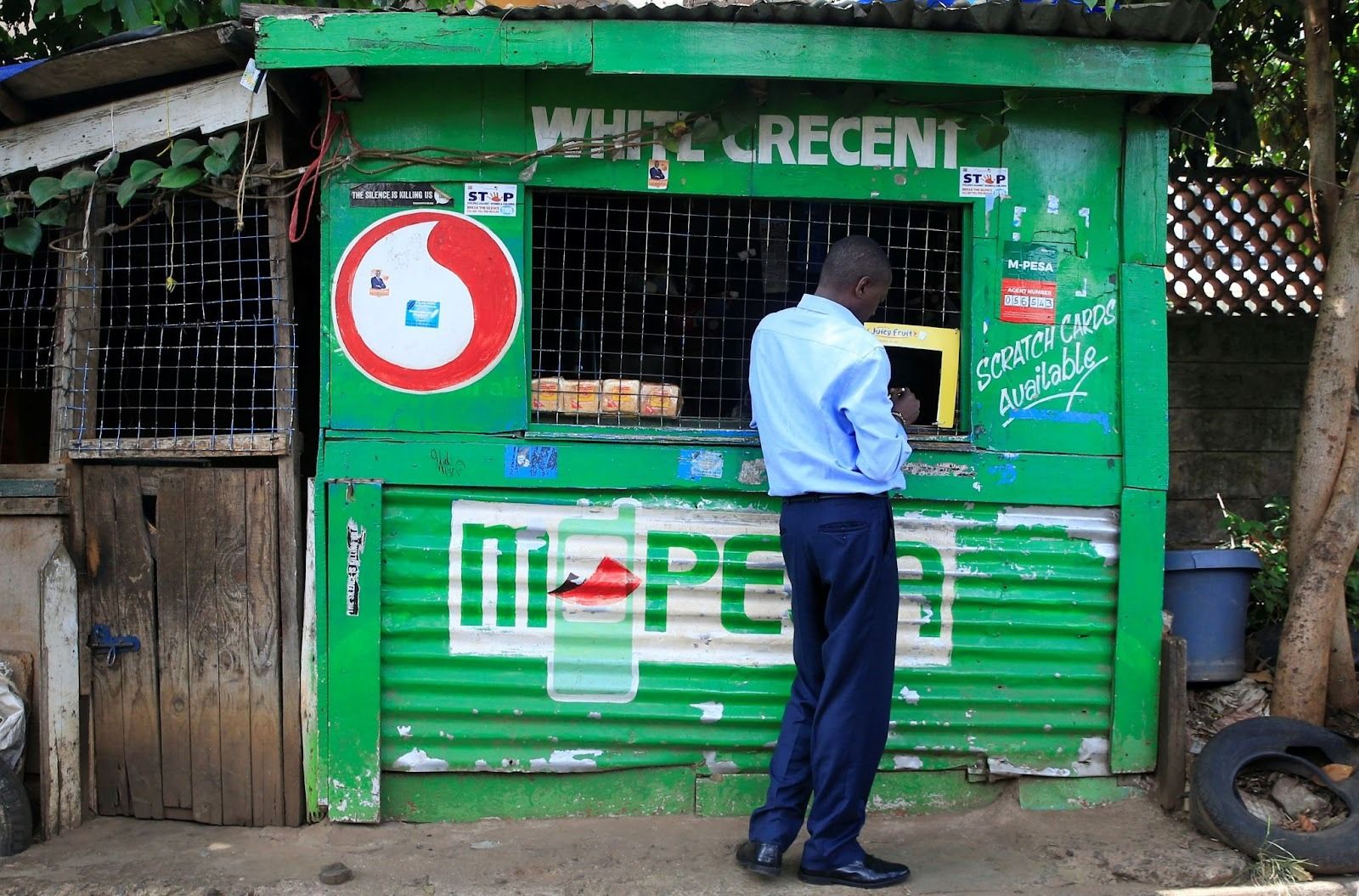 A man conducts a mobile money transfer at a Safaricom agent stall in Nairobi on Oct. 16, 2018.