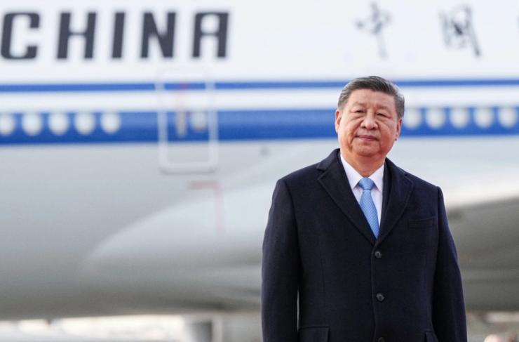 Chinese leader Xi Jinping stands on the tarmac in Russia.