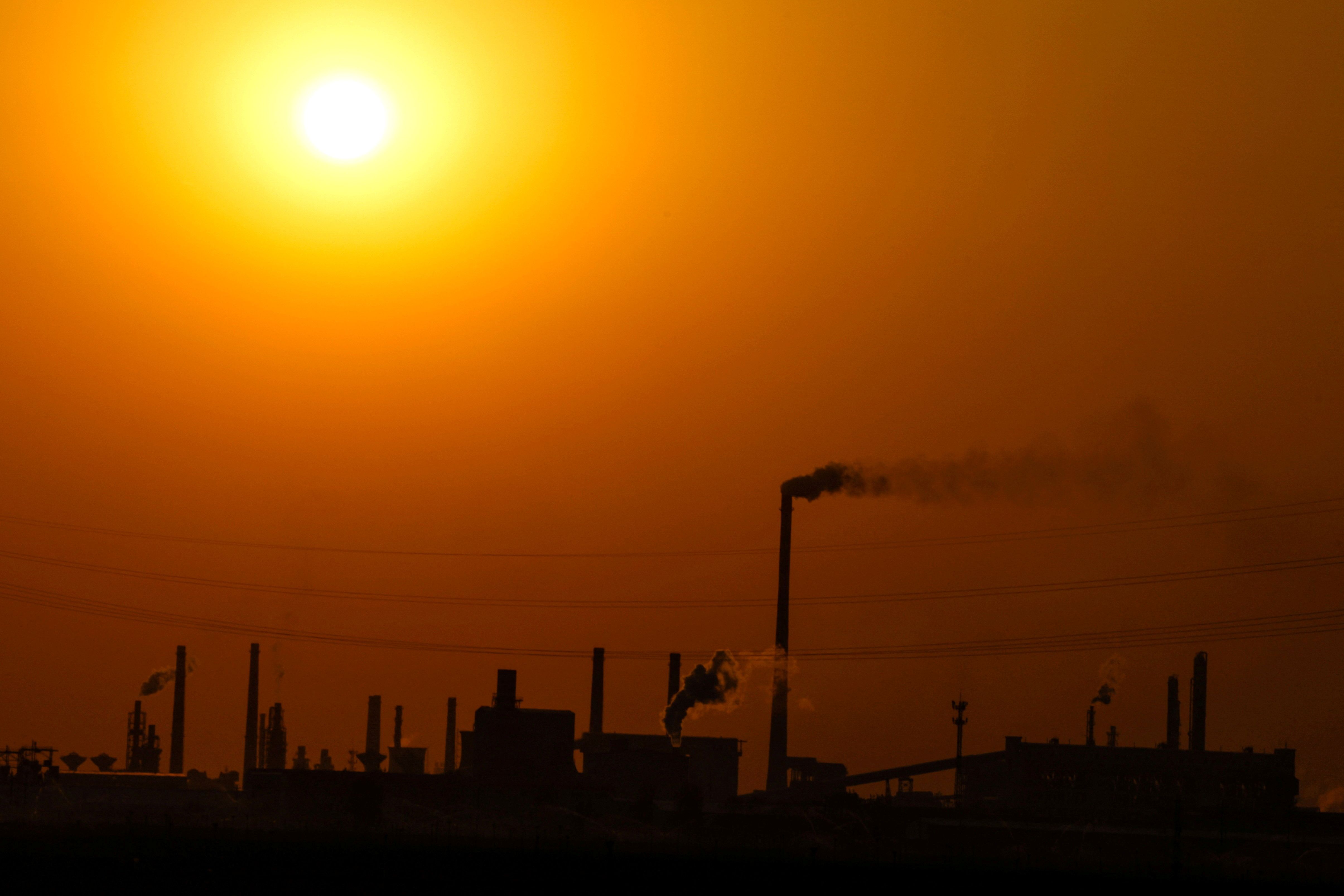  Factories are silhouetted during sunset, in Handan, China.
