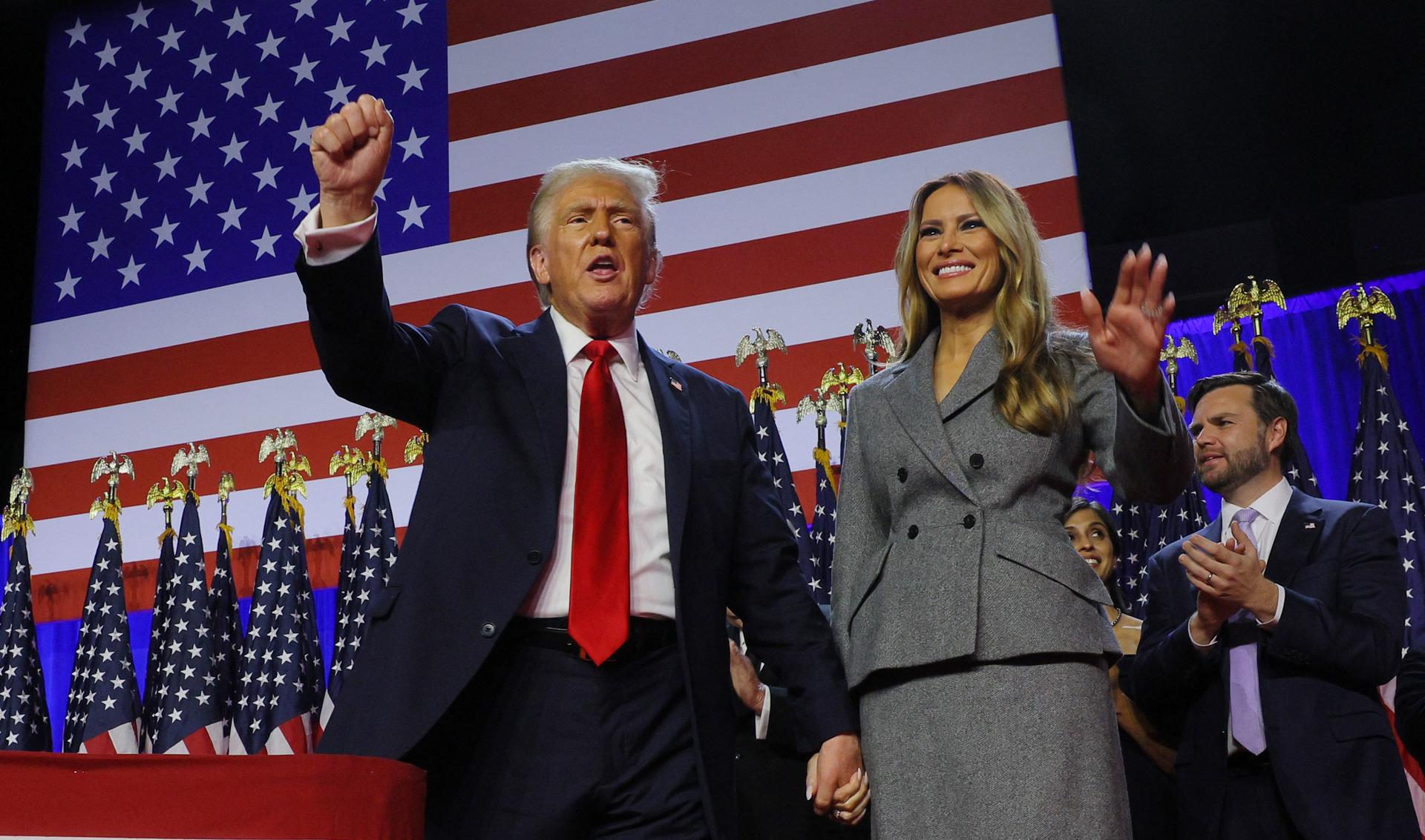 Former US President Donald Trump stands on stage.