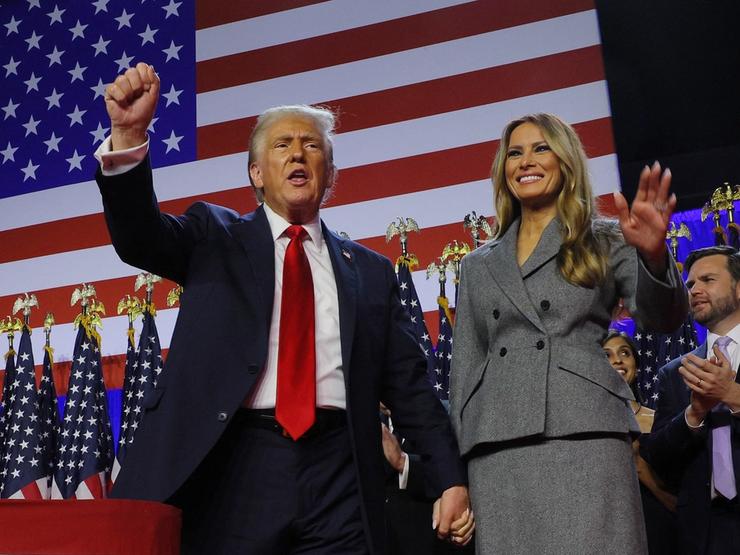 Former US President Donald Trump stands on stage.