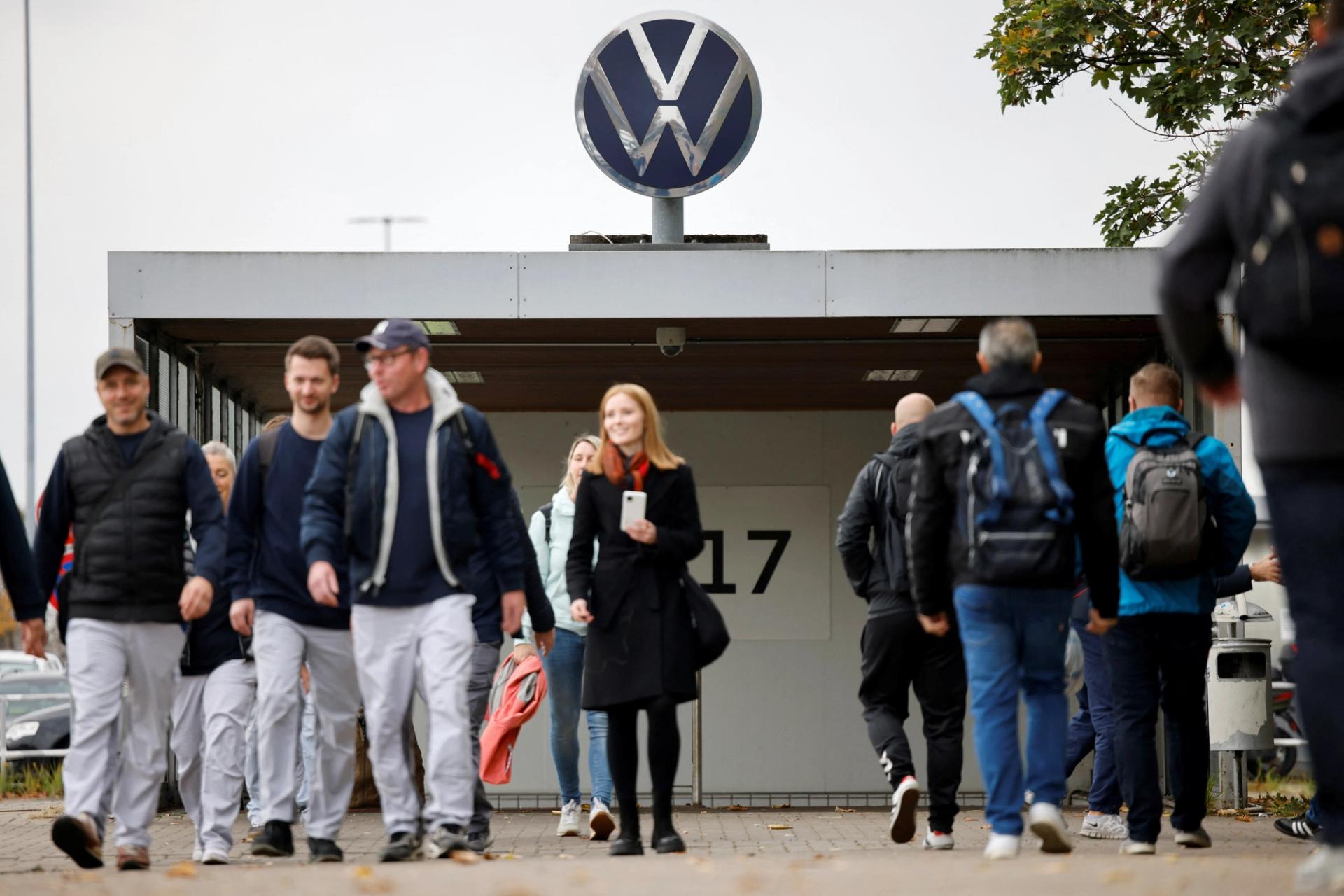 Employees walk on a day of an announcement of Volkswagen AG job cuts and closure of its few factories, at the company’s headquarters in Wolfsburg