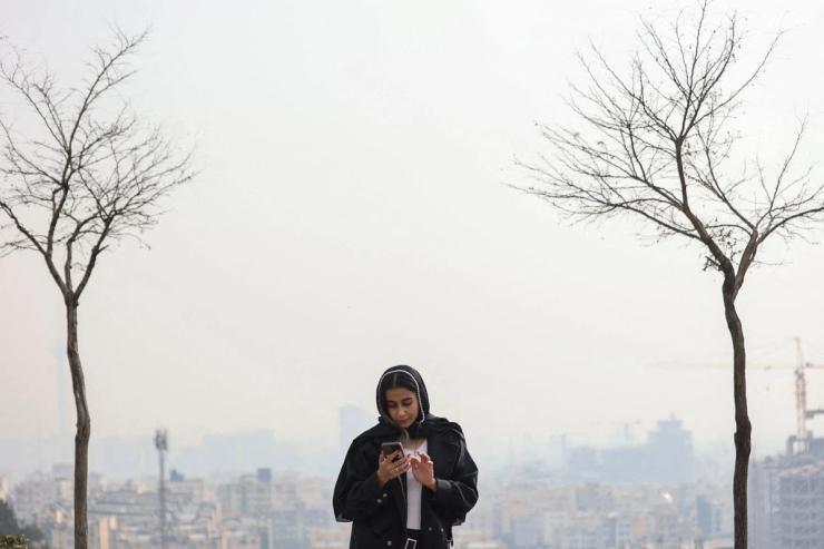 An Iranian woman looking at her mobile phone.