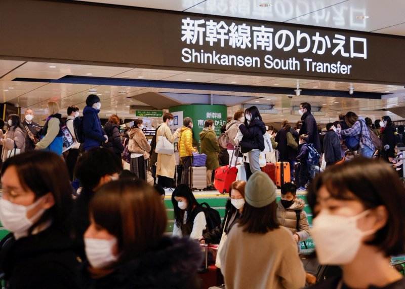 Passengers crowd as they wait for the service of the Shinkansen bullet train to restart, after it has temporarily suspended service due to an electric stoppage, at Tokyo Station in Tokyo, Japan, December 18, 2022.