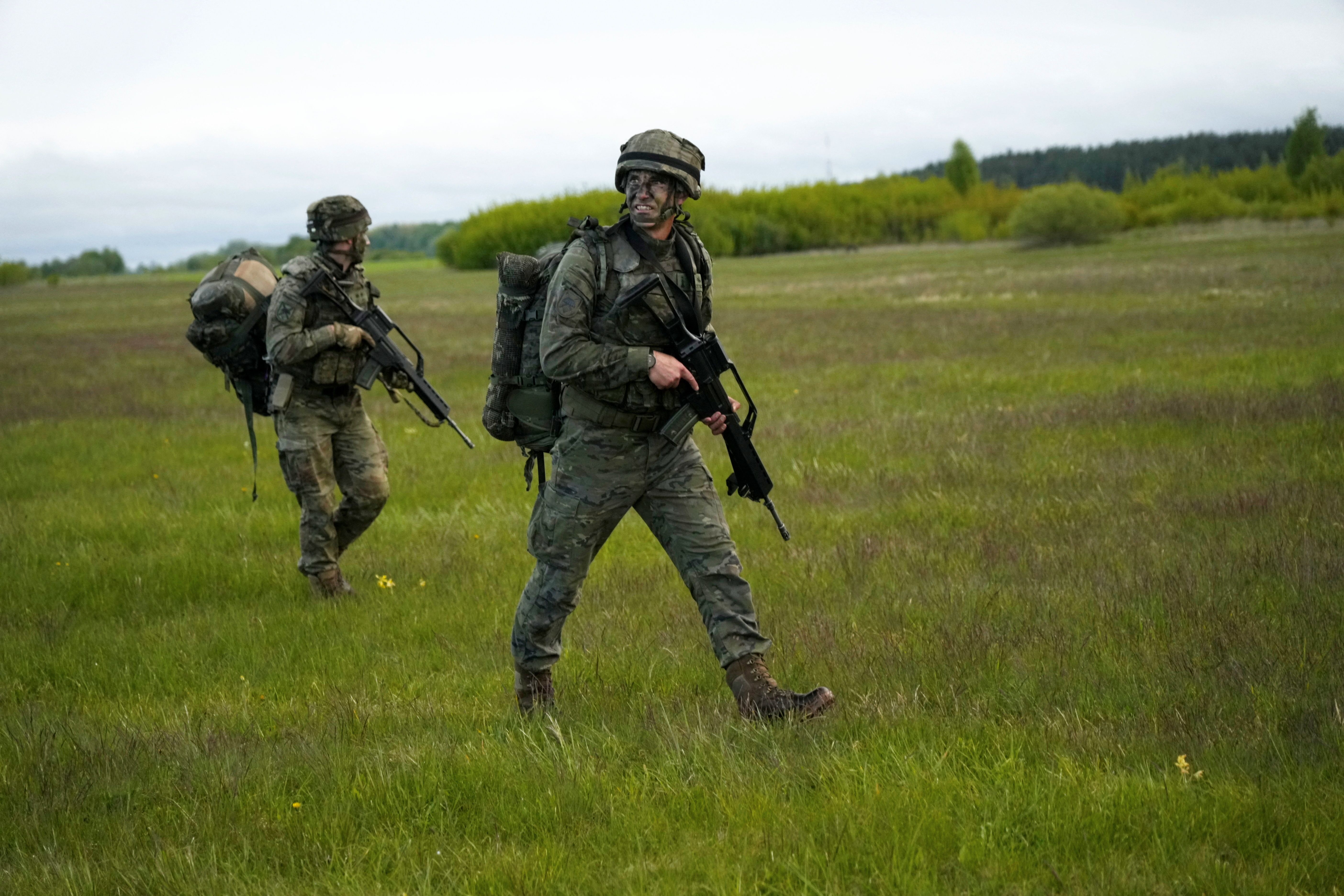 Paratroopers of Spanish army 6th airborne brigade walk to their positions after landing during NATO U.S. led “Swift Response 2025” military exercise near Daugavpils.