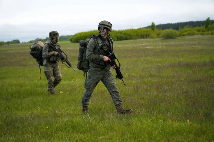 Paratroopers of Spanish army 6th airborne brigade walk to their positions after landing during NATO U.S. led “Swift Response 2025” military exercise near Daugavpils.