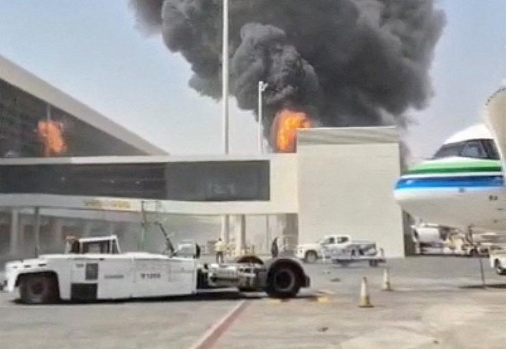 Smoke and flames rise from King Khalid airport after Houthi attack.