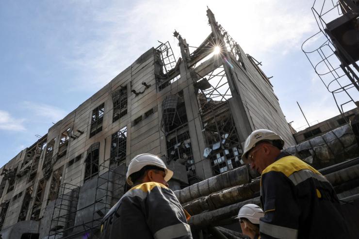 Thermal power plant employees appear on site at the building damaged by recent Russian missile strikes, amid Russia’s attack on Ukraine, at an undisclosed location in the west of Ukraine May 2, 2024