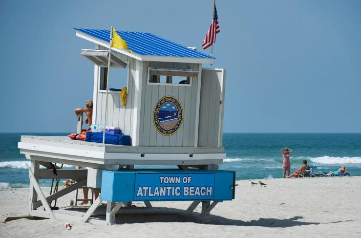 Visitors enjoy a sunny day on an empty beach two days before the expected arrival of Hurricane Irene in Atlantic Beach, North Carolina.