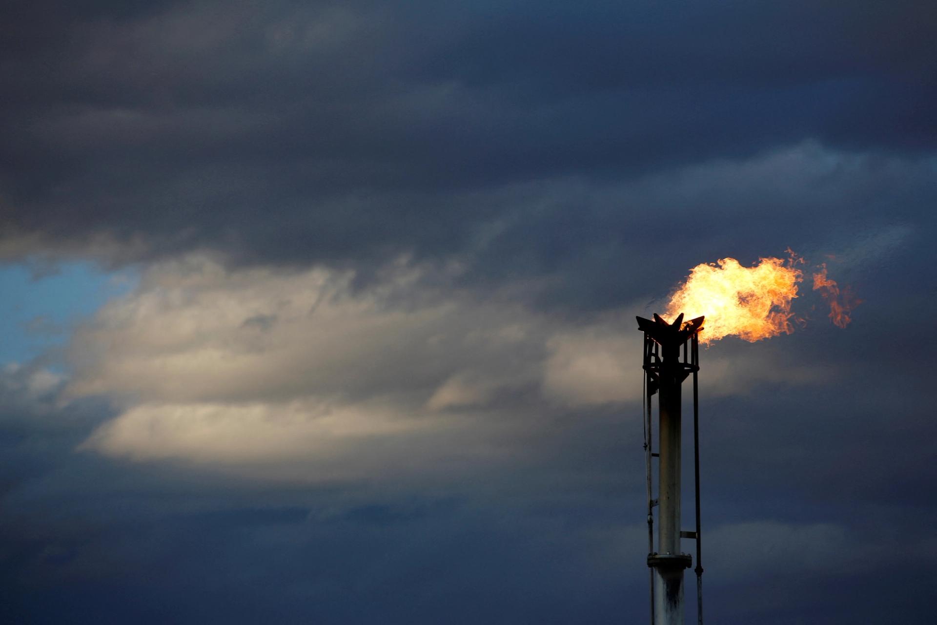 A flare burns off excess gas from a gas plant in the Permian Basin in Loving County