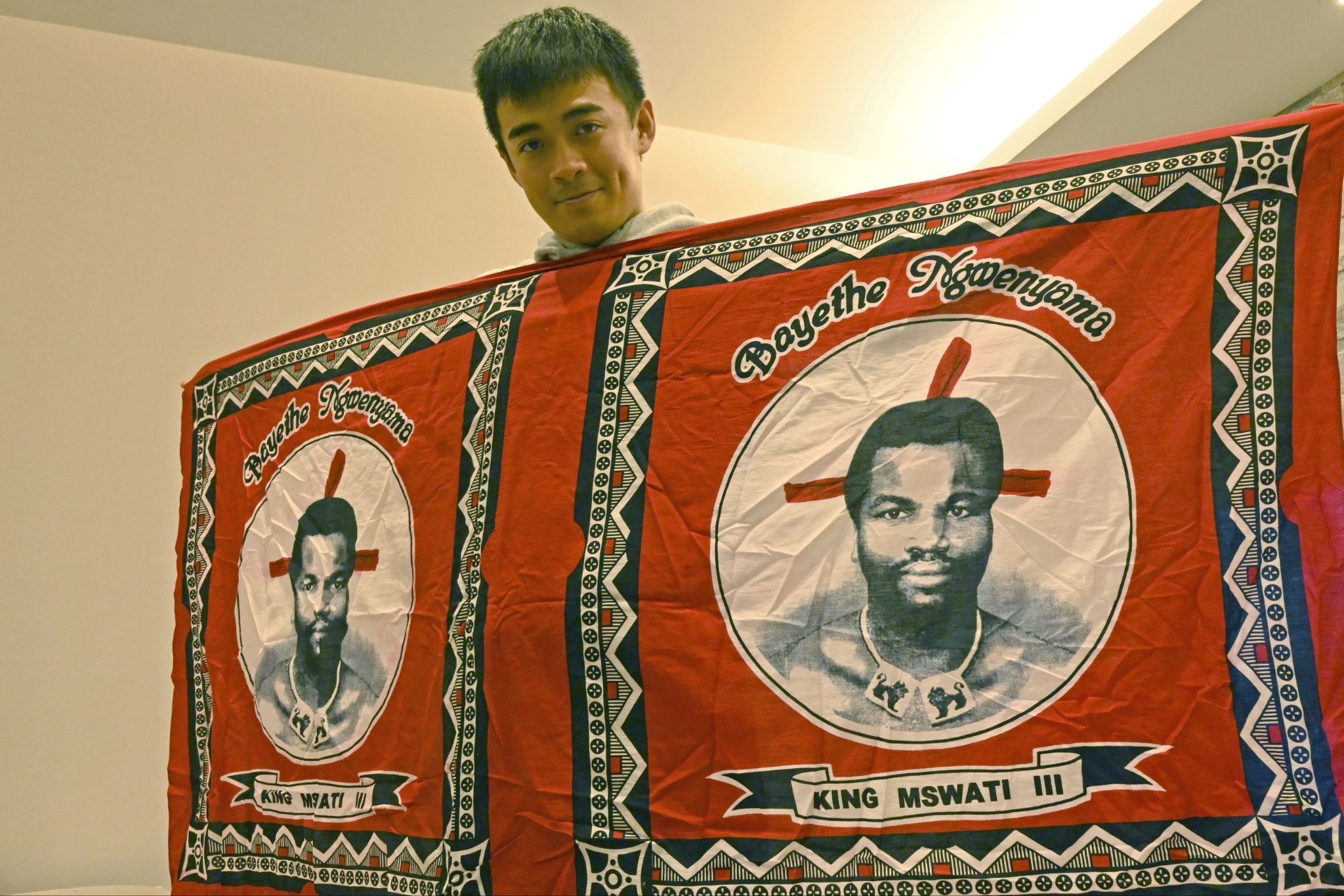 A Taiwanese activist holds a flag displaying the face of King Mswati III of Eswatini, Taiwan’s only diplomatic ally on the continent.