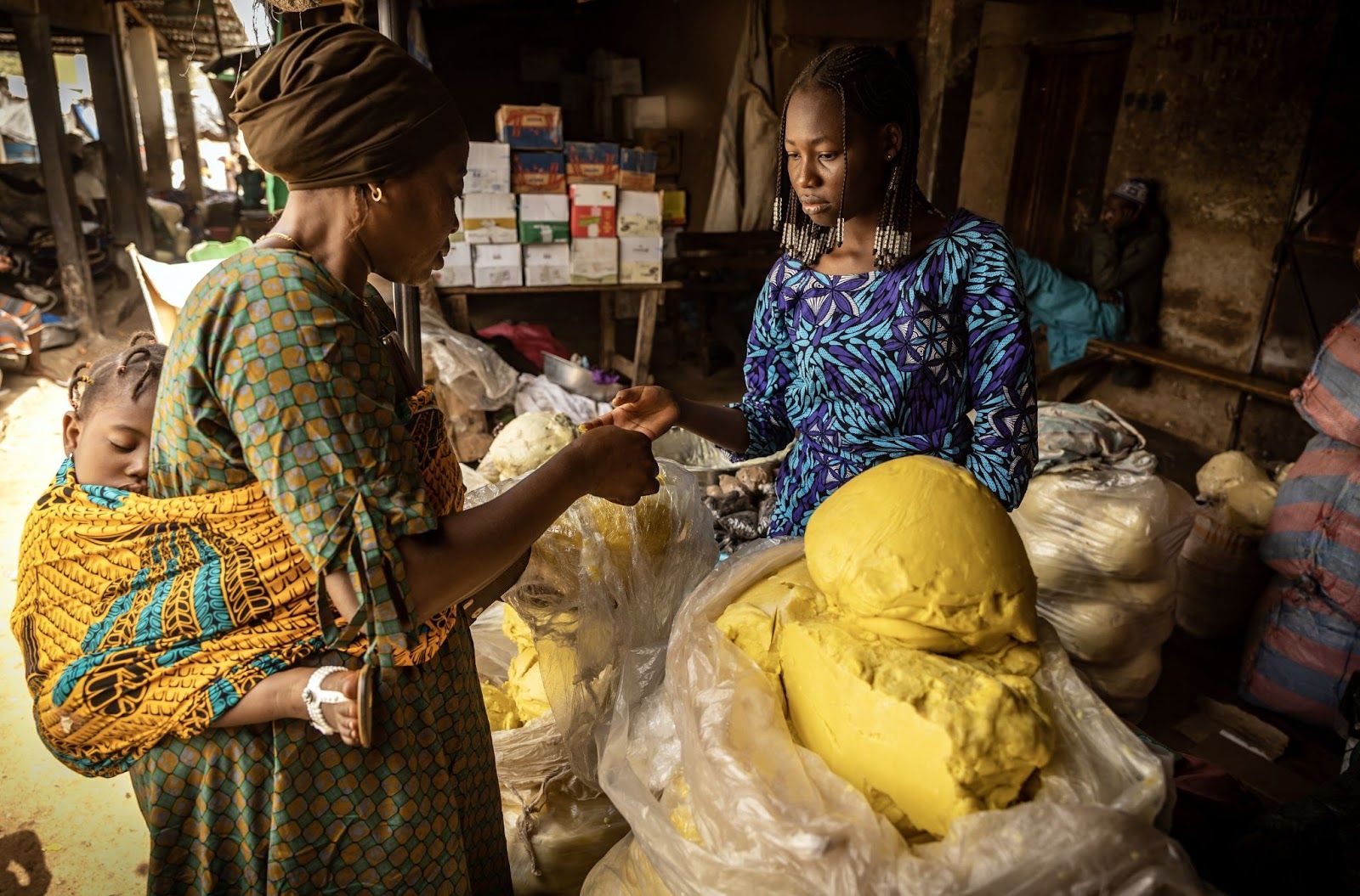 A vendor sells shea butter at an artisanal factory in Korhogo, Côte d’Ivoire.