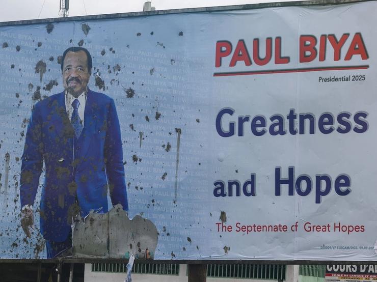 A vandalized campaign billboard depicting Cameroon’s President Paul Biya in Douala, Cameroon