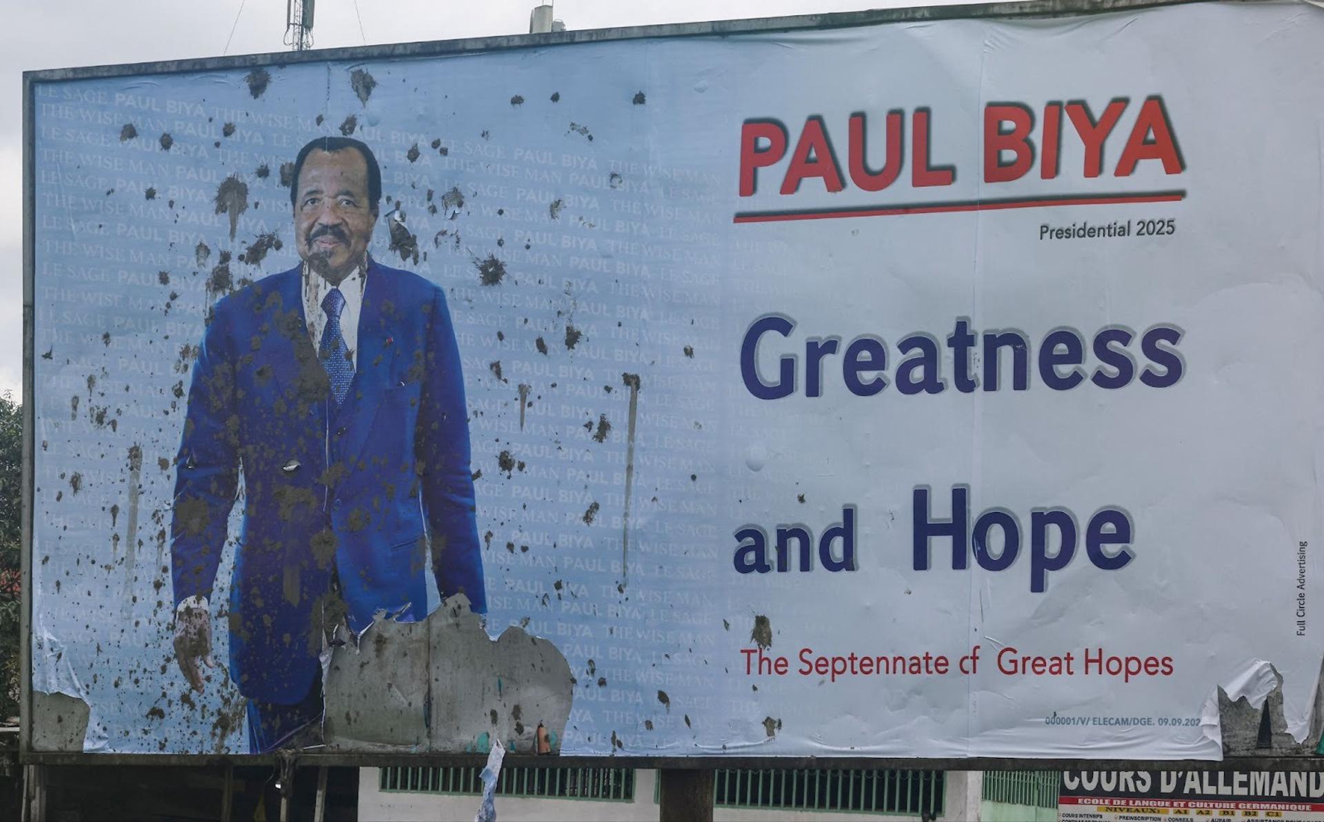 A vandalized campaign billboard depicting Cameroon’s President Paul Biya in Douala, Cameroon