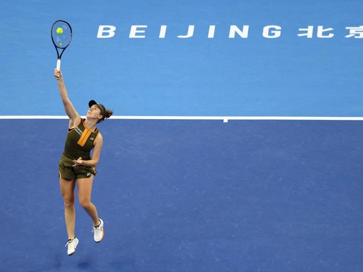 Woman playing tennis in Beijing arena