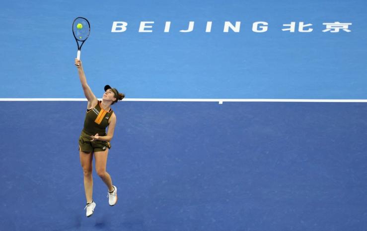 Woman playing tennis in Beijing arena