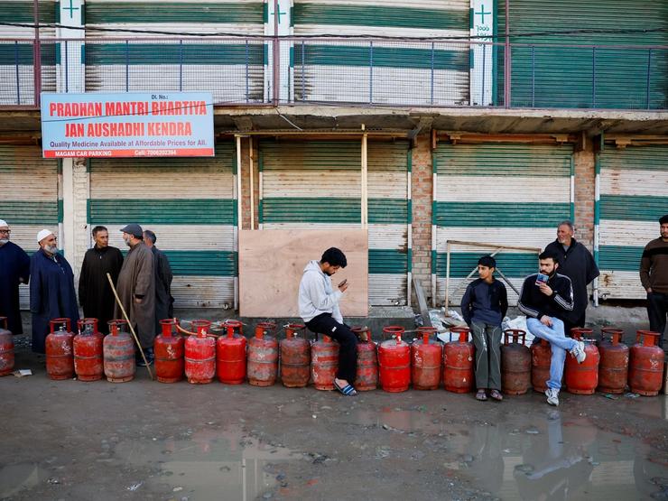 People wait in a queue with their empty LPG cylinders outside a gas agency amid supply disruptions following the U.S.-Israeli conflict with Iran, in Magam town, Indian Kashmir