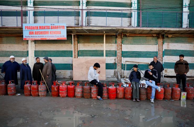 People wait in a queue with their empty LPG cylinders outside a gas agency amid supply disruptions following the U.S.-Israeli conflict with Iran, in Magam town, Indian Kashmir